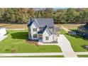 Two-story house with white brick and a gray roof, aerial view at 212 Meadow Walk Dr, Fuquay Varina, NC 27526