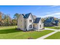 Two-story house with white brick and a gray roof, aerial view at 212 Meadow Walk Dr, Fuquay Varina, NC 27526