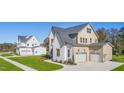 Two-story house with white brick and a gray roof, aerial view at 212 Meadow Walk Dr, Fuquay Varina, NC 27526