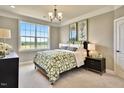 Bedroom with a bed, nightstands, and large window at 902 Sw Maynard Rd, Cary, NC 27511