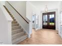 Bright entryway with hardwood floors, staircase, and double doors at 46 Otter Hole Dr, Princeton, NC 27569