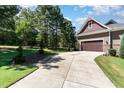 Long driveway leading to a two-car garage at 9 Mist Wood Court, Pittsboro, NC 27312