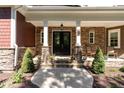 Front porch with stone pillars and double doors at 9 Mist Wood Court, Pittsboro, NC 27312