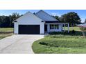Charming one-story home with a black garage door at 194 Lotus Ave, Smithfield, NC 27577
