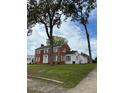 Two-story house with white and brick exterior, spacious lawn at 110 S Layton Avenue, Dunn, NC 28334