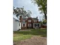 Back of the house showcasing a screened porch and patio at 110 S Layton Avenue, Dunn, NC 28334