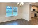 Bright dining room with hardwood floors, chandelier, and view of kitchen at 168 Newport Lndg, Garner, NC 27529