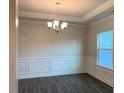 Bright dining room with hardwood floors and wainscoting at 168 Newport Lndg, Garner, NC 27529