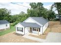 Newly built home with a white exterior, gray roof, and a small front porch at 217 Temple Ave, Sanford, NC 27330