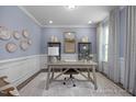 Bright home office with a desk, shelving, and calming decor at 5045 Trotter Dr, Raleigh, NC 27603