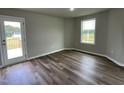 Bedroom with door leading to a deck and hardwood floors at 749 Sherrill Farm Dr, Benson, NC 27504