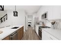 Modern kitchen with stainless steel appliances and hardwood floors at 4038 Elk Creek Ln # 60, Raleigh, NC 27612
