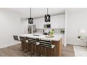 Modern kitchen with island, stainless steel appliances, and white cabinetry at 4038 Elk Creek Ln # 60, Raleigh, NC 27612