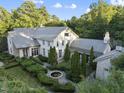 Aerial view of a home, showing its architecture, landscaping, and a fountain at 3319 White Oak Rd, Raleigh, NC 27609