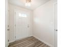 Bright entryway with wood-look flooring and a white door at 1109 Pale Moss Dr, Durham, NC 27704