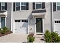 Townhouse exterior with a dark green door and white garage at 1109 Pale Moss Dr, Durham, NC 27704