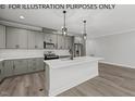 Modern kitchen with gray cabinets, white island, and stainless steel appliances at 102 Mayan Dr, Louisburg, NC 27549