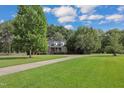 Brick home with circular driveway, lush landscaping, and spacious yard at 1100 Branch Chapel Church Rd, Selma, NC 27576