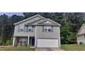 Gray two-story house with stone accents and a double garage at 700 Quail Ct, Creedmoor, NC 27522