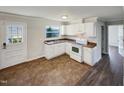 White kitchen with brown tile floor and stainless steel appliances at 225 W Orange St, Hillsborough, NC 27278