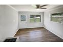 Bedroom with wood-look flooring, white door, and windows at 225 W Orange St, Hillsborough, NC 27278