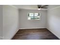 Bright bedroom with wood-look flooring and ceiling fan at 225 W Orange St, Hillsborough, NC 27278