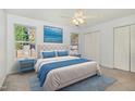 Bright bedroom with blue accents, ceiling fan, and two closets at 108 Hiddenwood Ct, Garner, NC 27529