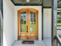 Elegant double wooden front door with arched glass panels at 2804 Jack Mitchell Rd, Zebulon, NC 27597