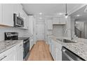 Modern kitchen with stainless steel appliances and granite countertops at 100 Carol Cir, Louisburg, NC 27549