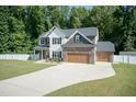 Two-story house with stone accents, a large yard, and a two-car garage at 159 Shady Oaks Dr, Benson, NC 27504