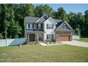 Two-story house with stone accents, a large yard, and a two-car garage at 159 Shady Oaks Dr, Benson, NC 27504