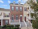 Brick three-story townhouse with purple shutters and stairs at 10410 Sablewood Dr # 111, Raleigh, NC 27617