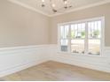 Bright dining room with wainscoting and hardwood floors at 2074 Burch Bridge Rd, Burlington, NC 27217