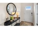 Bright entryway with console table, mirror, and elegant lighting at 6421 Alfalfa Ln, Wake Forest, NC 27587
