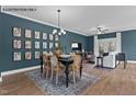 Open concept dining area with hardwood floors and gallery wall at 1111 Breadsell Ln # 51, Wake Forest, NC 27587