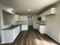 Modern kitchen featuring white cabinets, granite countertops, and stainless steel appliances at 80 Lotus Ave, Smithfield, NC 27577