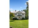 Two-story white farmhouse with a lush green lawn at 1502 Bahama Rd, Bahama, NC 27503