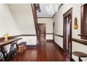 Long hallway with hardwood floors, a chandelier, and vintage decor at 1502 Bahama Rd, Bahama, NC 27503