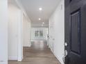 Open foyer with wood-look flooring and view into the living area at 1208 Randwick Valley Ct, Zebulon, NC 27597