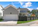 Attached garage with white door and black fence at 1029 Whitehall Cir, Durham, NC 27713