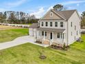 Two story home with three car garage and landscaped yard at 122 Whimbrel Ct, Lillington, NC 27546