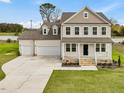 Two story house with three car garage and front porch at 122 Whimbrel Ct, Lillington, NC 27546