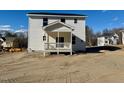 New construction home showcasing a rear wooden deck and expansive backyard at 199 Grand Griffon Way, Lillington, NC 27546