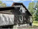 Rustic one-story home with wooden siding needing some repairs at 255 Roberts Ave, Henderson, NC 27537