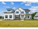 Farmhouse-style home with white siding and stone accents at 3408 Apple Meadow Dr, Fuquay Varina, NC 27526