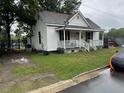 White house with front porch, satellite dish and small yard at 206 S Ethel St, Selma, NC 27576
