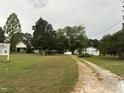 Aerial view of property with two houses and a large yard at 4516 Us 301, Four Oaks, NC 27524