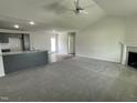 Open living room with high ceilings, fireplace, and kitchen island at 170 Lotus Ave, Smithfield, NC 27577