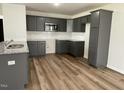 Modern kitchen featuring granite countertops and gray cabinetry at 170 Lotus Ave, Smithfield, NC 27577