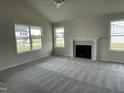 Bright living room featuring a cozy fireplace and large windows at 116 Lotus Ave, Smithfield, NC 27577